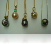 A set of five South Sea pearl pendants, each featuring a different gemstone